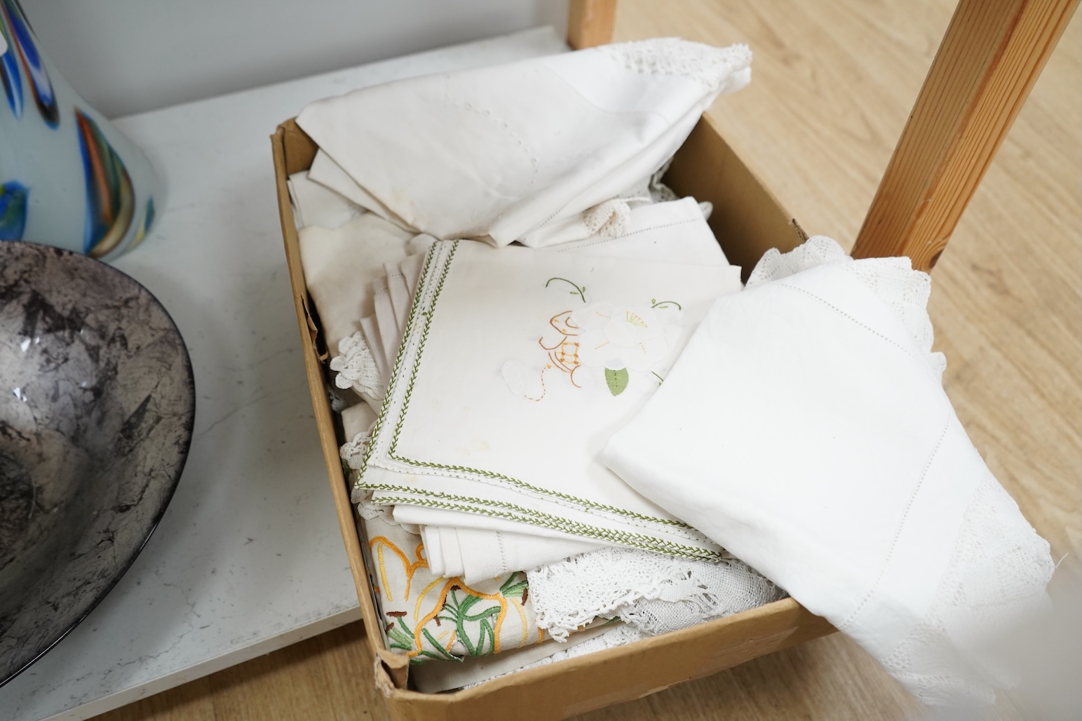 A collection of embroidered and crochet linen table cloths etc